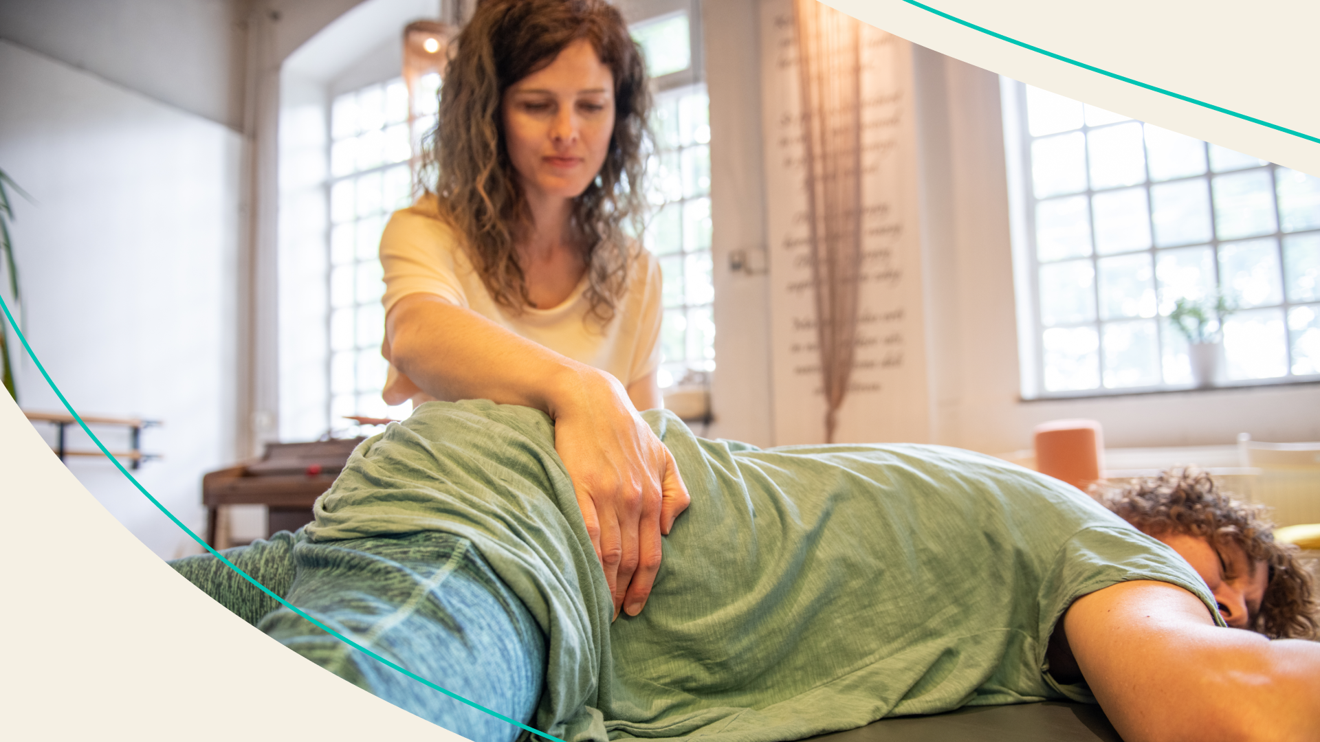 A somatic practitioner working with a client by placing her hands on her hips