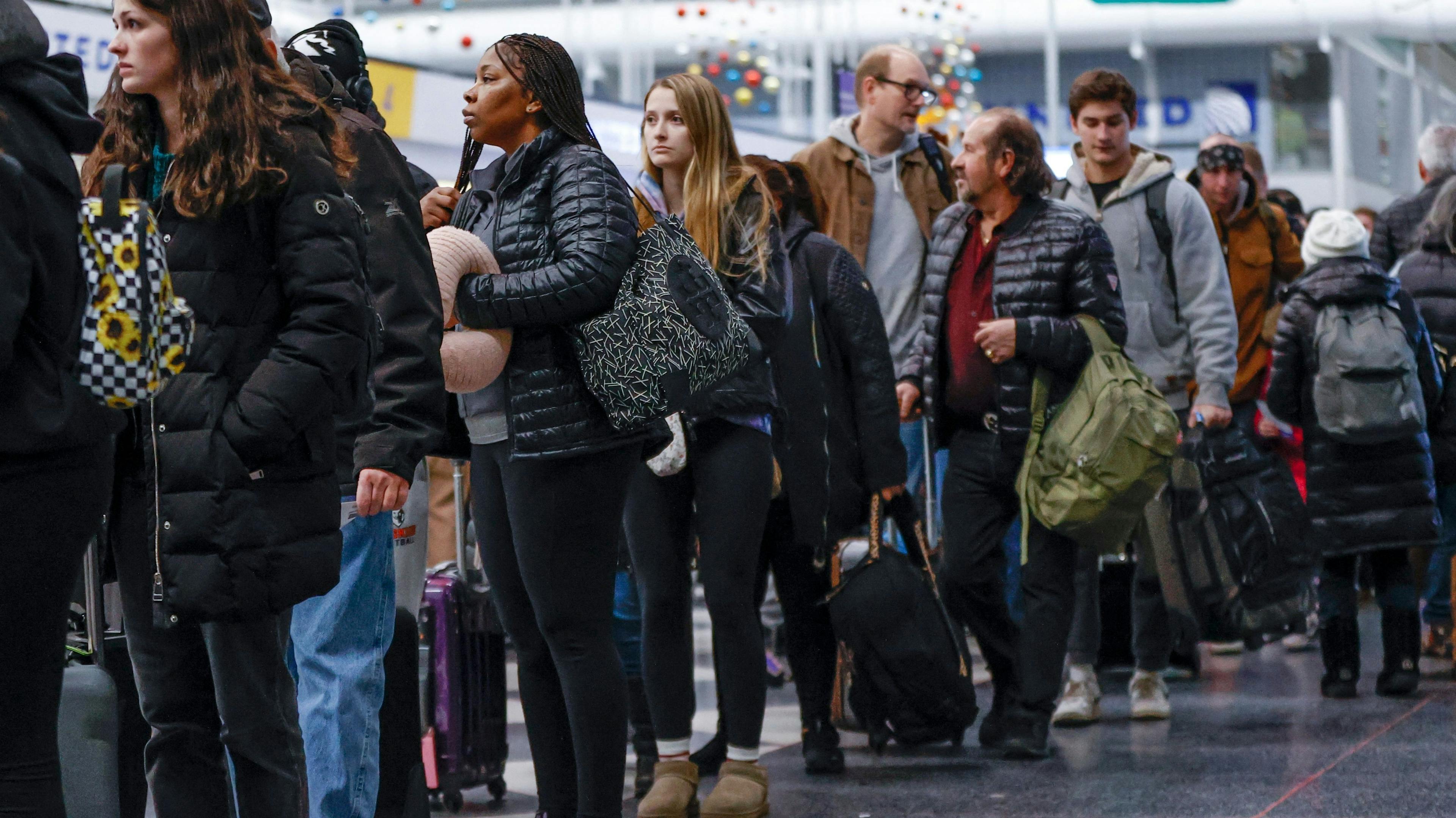 people standing in line at the airport