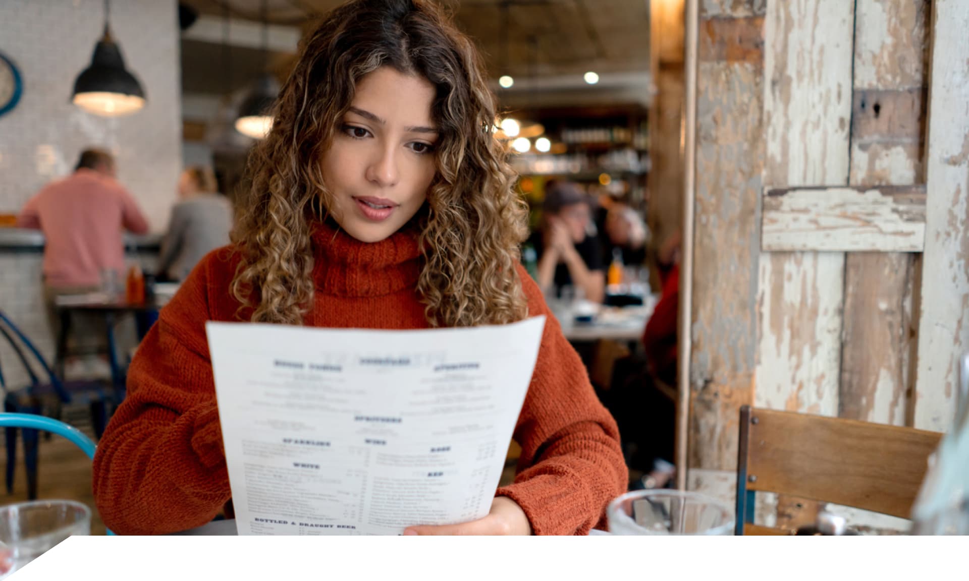 woman looking at food menu at restaurant