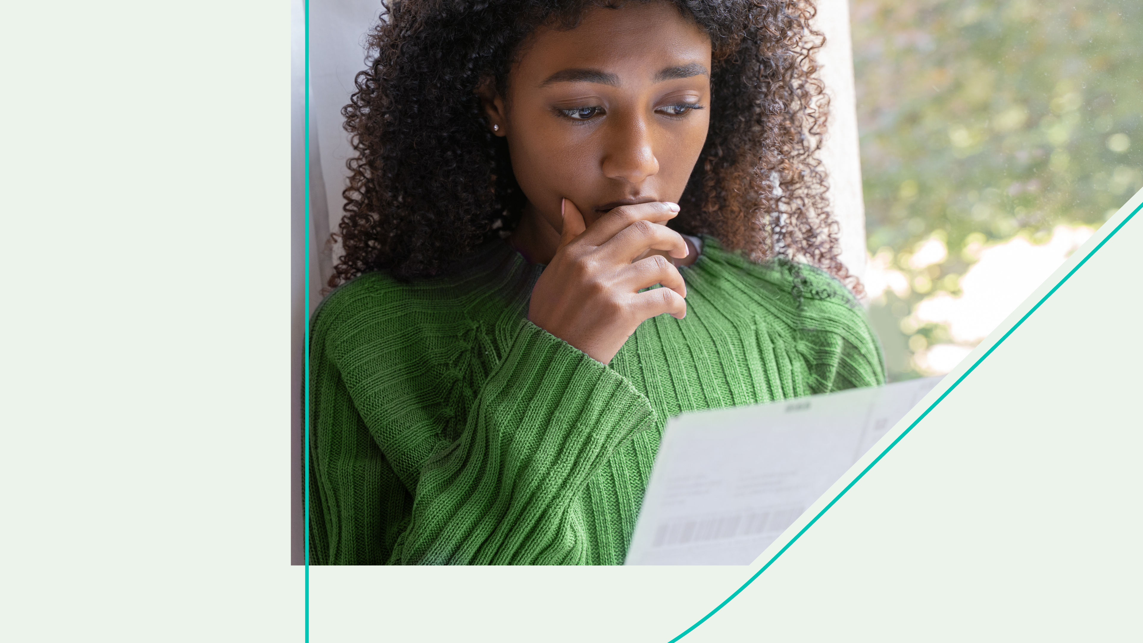 woman looks concerned while looking over paperwork