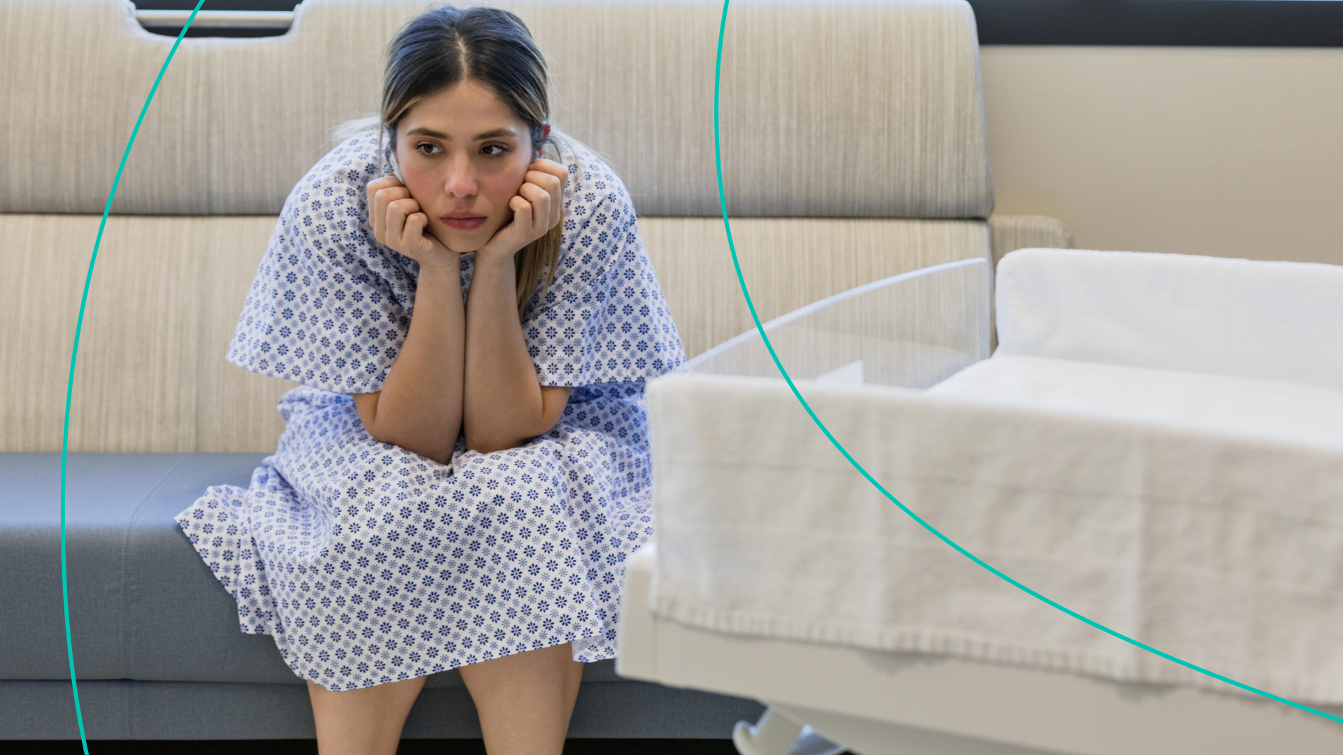 Woman with head in her hands in hospital gown