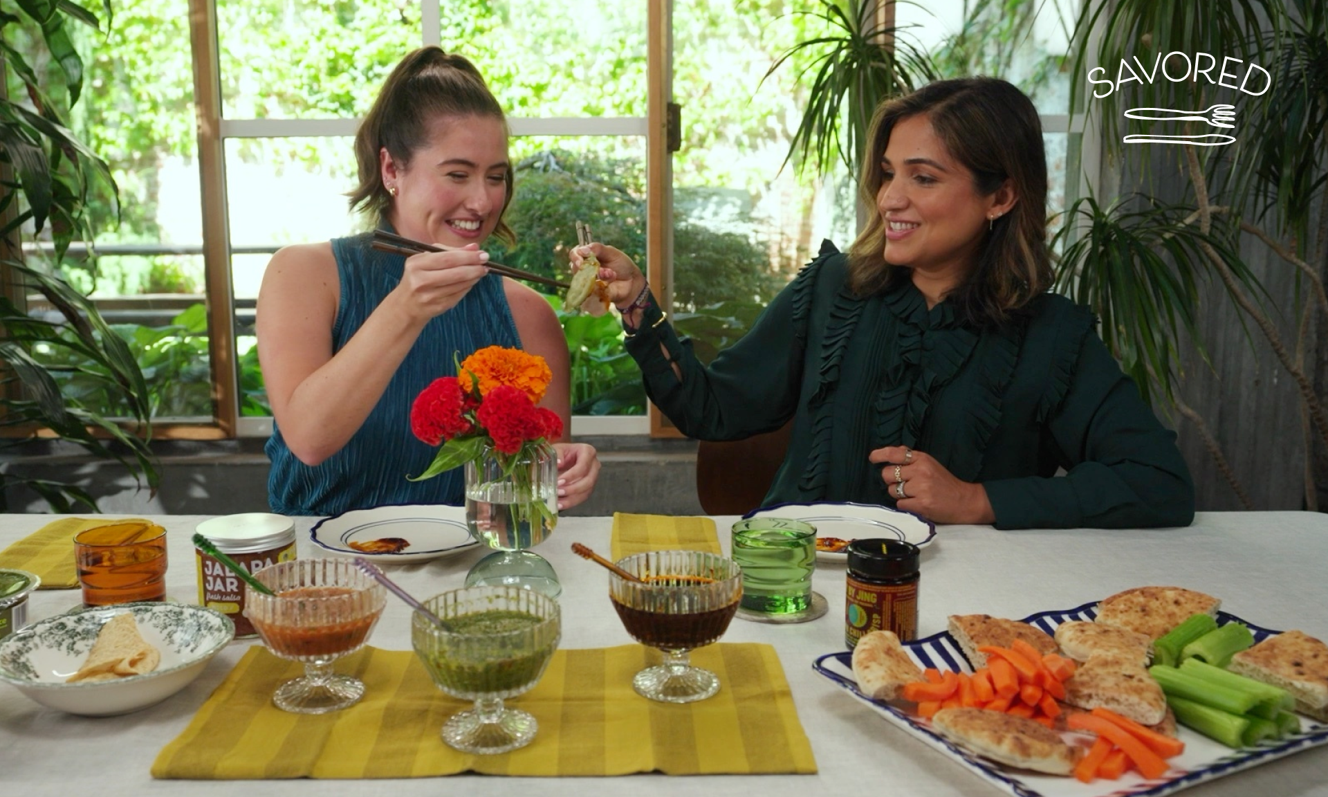 two women toasting with dumplings