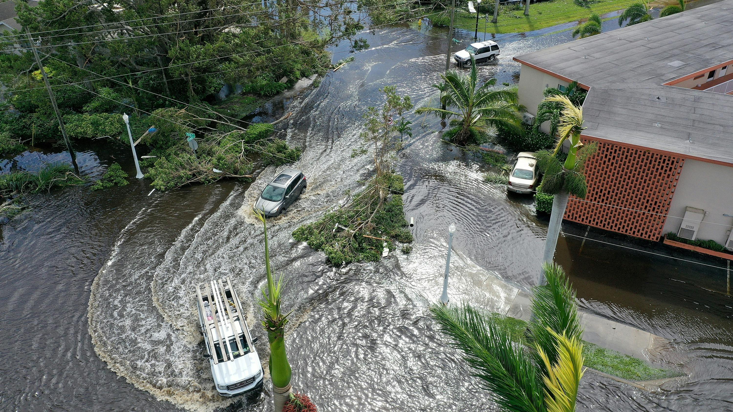 Hurricane Ian swirls cars in the road