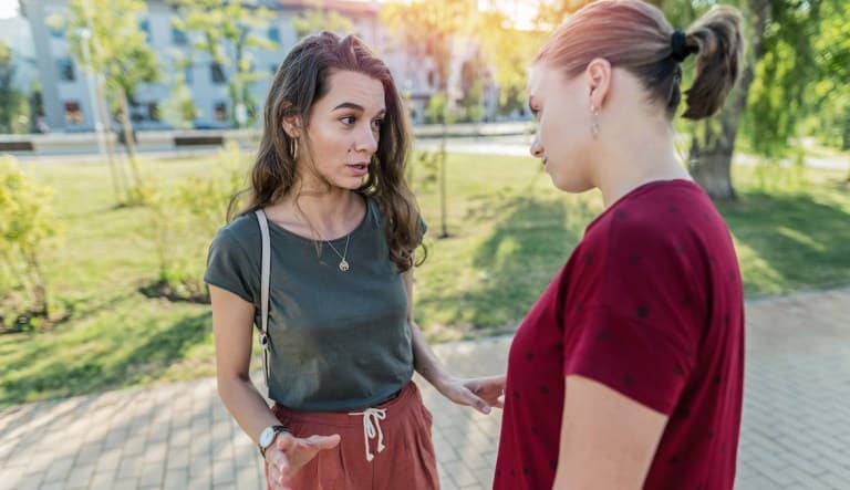 A female couple arguing outdoors in the park. This photo is being used to promote an article about the different types of manipulation.