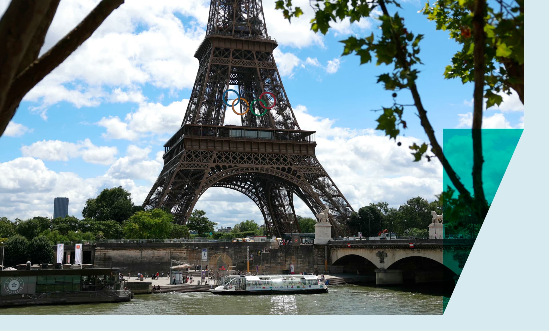 A Seine river bus boat docks in front the Eiffel Tower adorned with Olympic rings ahead of the Paris 2024 Olympic and Paralympic Games in Paris in July 16, 2024