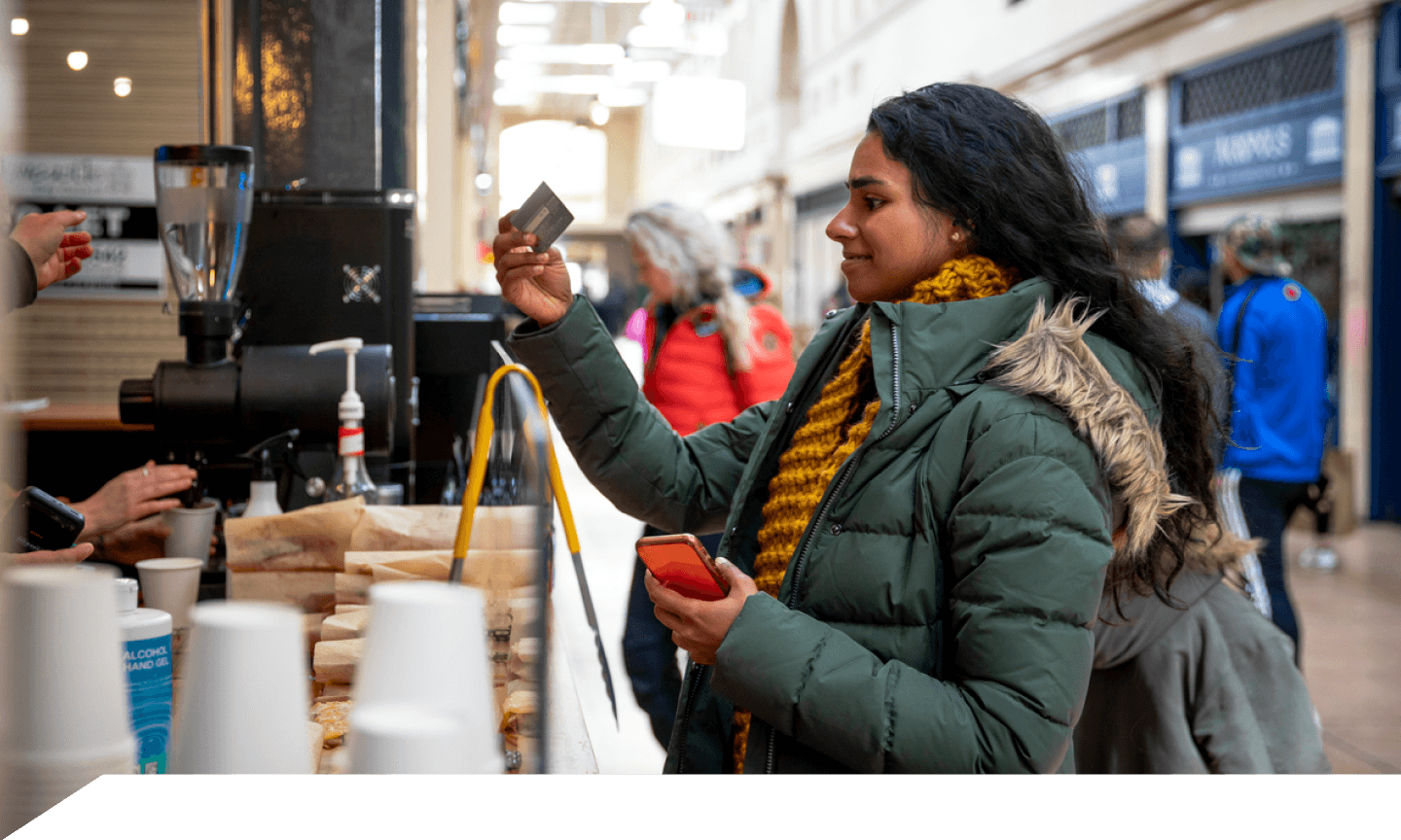 woman buying coffee with her credit card