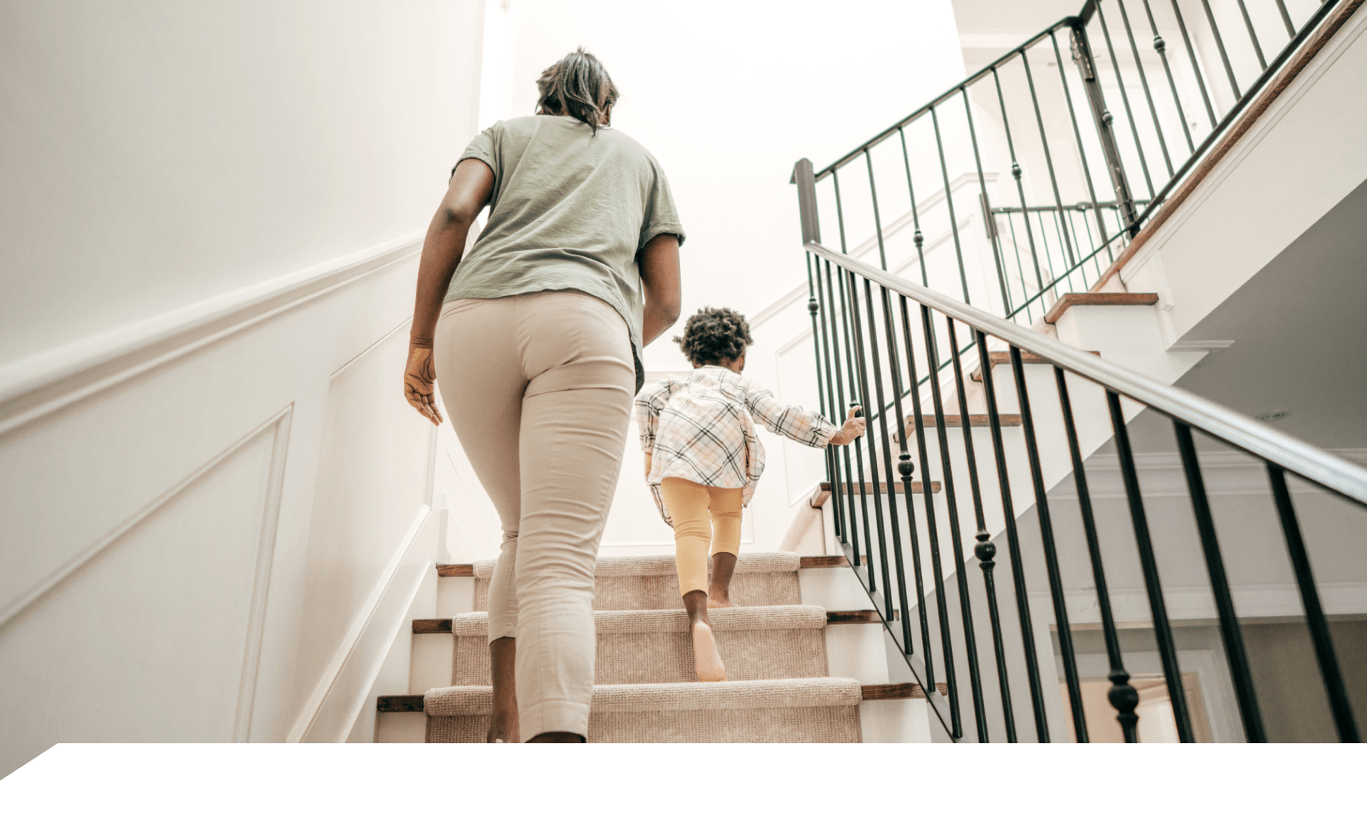 A woman walking up stairs holding a coffee cup