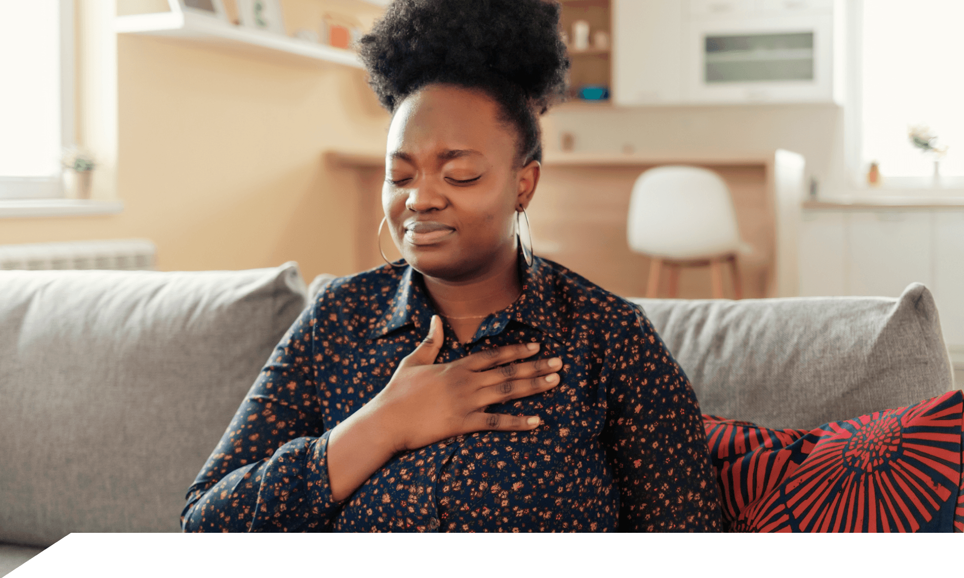 A woman with her hand on her chest looking uncomfortable