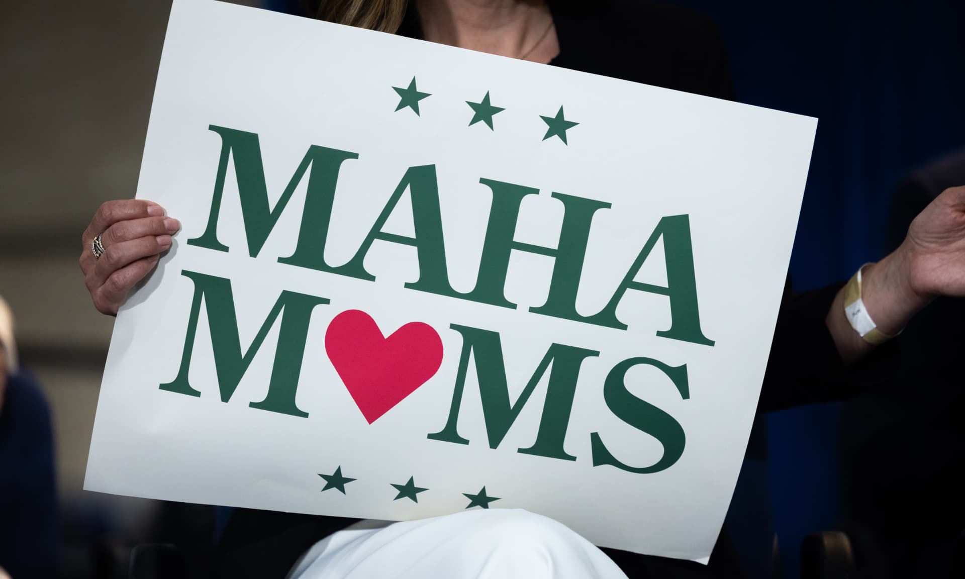 Woman holding MAHA moms sign
